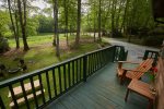 Charming deck with seating overlooking the lawn